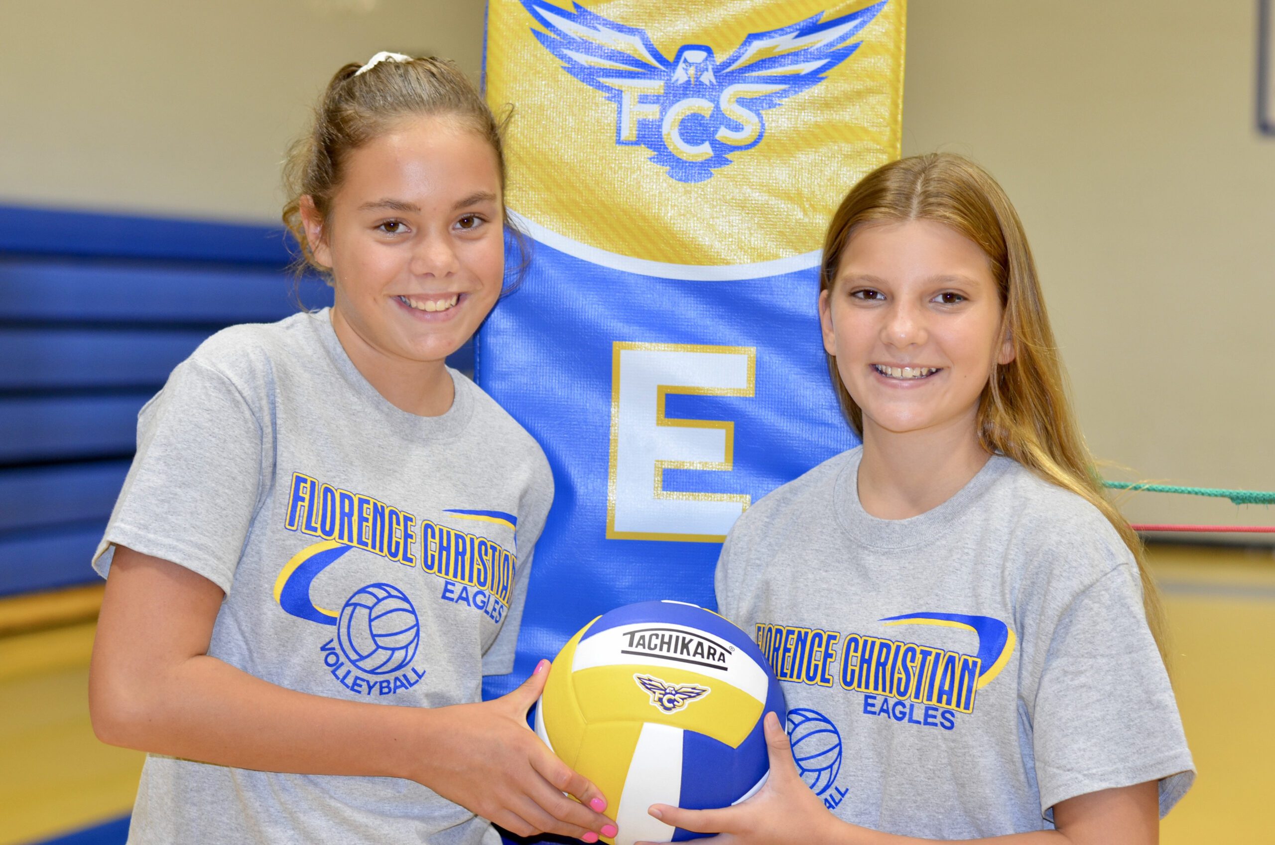 Two girls holding a volleyball at Florence Christian School