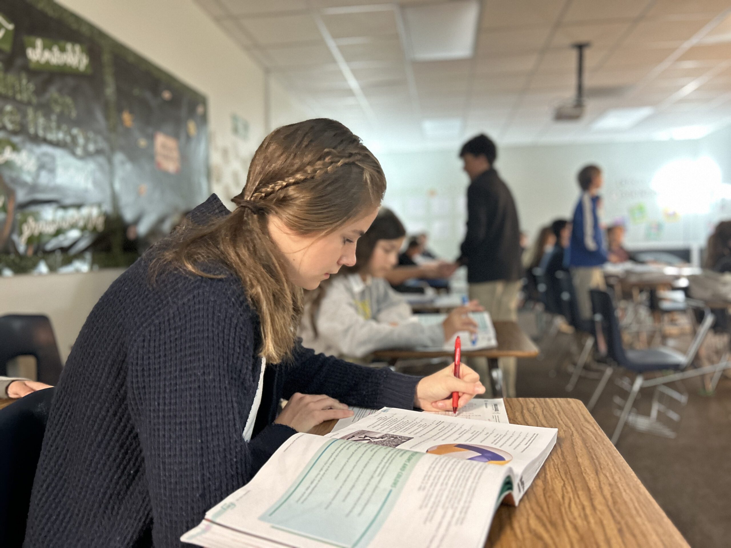 Core classes at Florence Christian School, a student writing notes during class